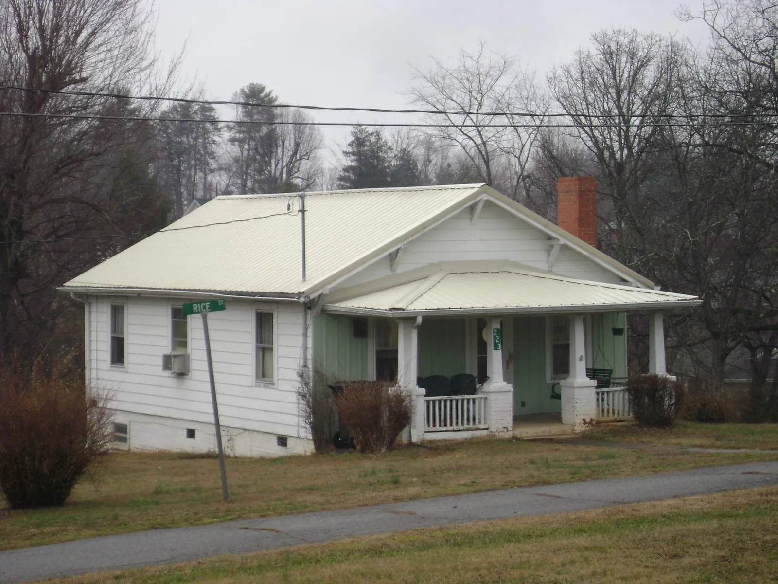 White metal roof on a craftsman bungalow at a street corner in New Freeport