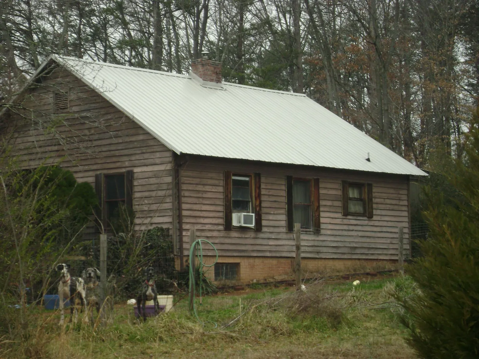 White metal roof on an old wood sided farmhouse, from a Metal Roof Installation job in New Freeport